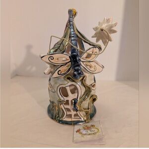 Whimsical Ceramic Fairy House
Blue sky includes bottom includes a bottom
Holder